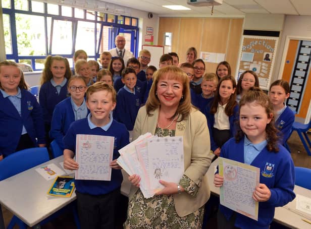 MP Sharon Hodgson with children from Castletown Primary School holding some of the letters they had wrote.