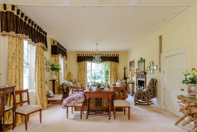 The 38ft double aspect drawing room is set into a bay window overlooking and opening on to the gardens and the former grass tennis court.