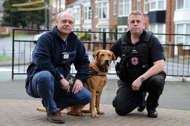 Tobacco search dog Cooper in action with handler Stuart Phillips and senior trading standards officer Alan Shaw.