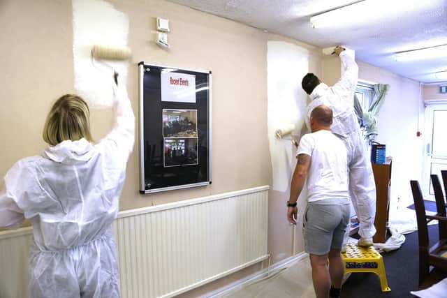 Gentoo volunteers painting the centre with paint donated from Bell Group.