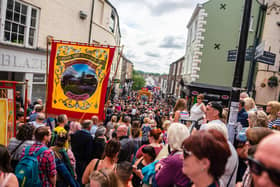 Banners march over Elvet Bridge at the 2019 Durham Miners Gala.