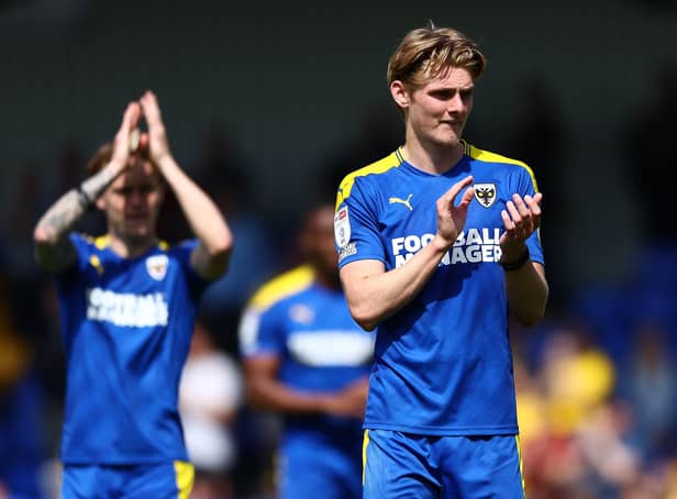 WIMBLEDON, ENGLAND - APRIL 30: Jack Rudoniof AFC Wimbledon  acknowledges the fans after AFC Wimbledon were relegated from League One during the Sky Bet League One match between AFC Wimbledon and Accrington Stanley at Plough Lane on April 30, 2022 in Wimbledon, England. (Photo by Bryn Lennon/Getty Images)