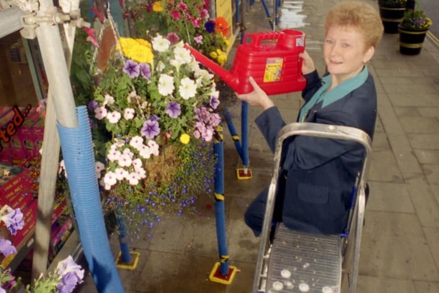 Linda Smith, children's wear specialist at Woolworths, is pictured looking after the flower baskets outside the store in Fawcett Street, Sunderland.