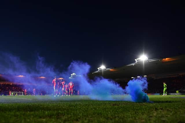PLYMOUTH, ENGLAND - NOVEMBER 27: A flare is seen on the pitch after Charlie Wyke of Wigan Athletic scored his side's second goal during the Sky Bet League One match between Plymouth Argyle and Wigan Athletic at Home Park on November 27, 2021 in Plymouth, England. (Photo by Dan Mullan/Getty Images)