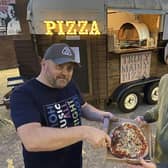 Jed Wade with his son Sam with a Pizza they have just cooked. Picture by FRANK REID