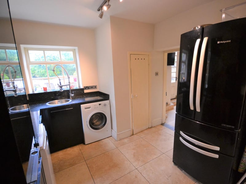 The utility room has granite worktops and contrasting gloss black units, with space and provisions for a washing machine, tumble drier and dishwasher.