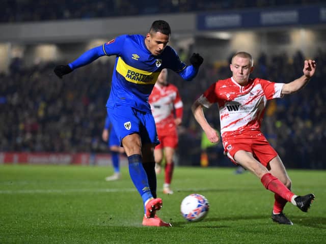 Ali Al-Hamadi (left) in action for AFC Wimbledon. (Photo by Justin Setterfield/Getty Images).