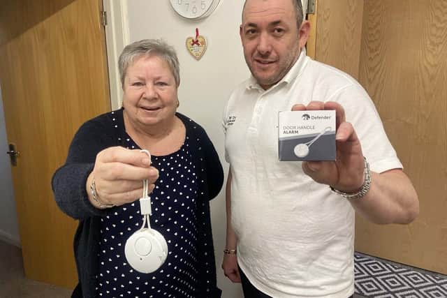 Phil Tye with Dot Brown as he fits alarms for those living in Silksworth. Picture by FRANK REID