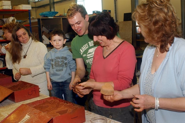 Glass worker Colin Brown helps visitors to the Glass Centre to make glass hearts for Valentine's Day in 2006.