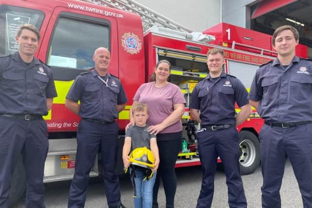 Logan Allison and mam Kimberley with firefighters from Tyne and Wear Fire and Rescue Service’s at Washington Community Fire Station.