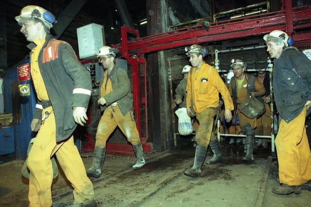 Men in their pit clothes leave the cages at Wearmouth Colliery after the last shift in 1993.
