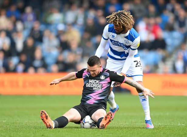 LONDON, ENGLAND - MARCH 20: Jack Marriott of Peterborough United is challenged by Dion Sanderson of Queens Park Rangers during the Sky Bet Championship match between Queens Park Rangers and Peterborough United at The Kiyan Prince Foundation Stadium on March 20, 2022 in London, England. (Photo by Alex Davidson/Getty Images)