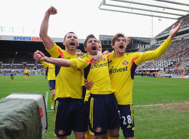 Fabio Borini (C) of Sunderland celebrates with teammates Phil Bardsley (L) and Marcos Alonso (R) after scoring the opening goal during the Barclays Premier League match between Newcastle United and Sunderland at St James' Park on February 1, 2014 in Newcastle upon Tyne, England.