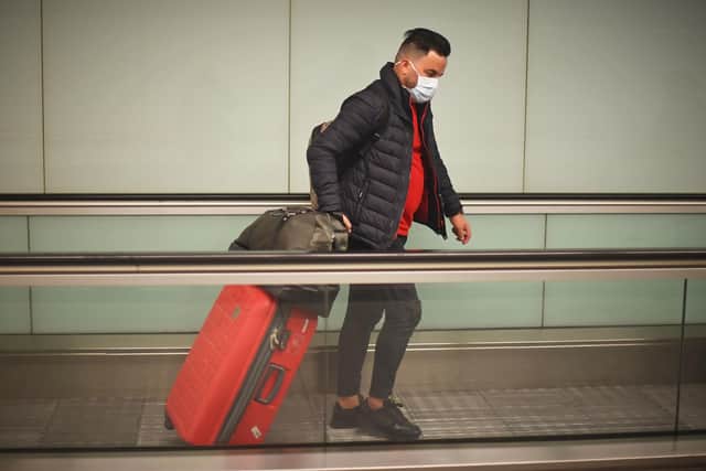 People wearing face masks arrive at Gatwick Airport. Picture: PA.