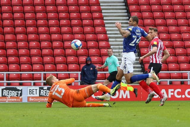 Ben Amos makes a strong early save from Charlie Wyke