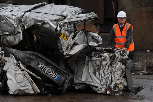 Councillor Paul Stewart, deputy leader of Sunderland City Council, with the crushed vehicles at EMR, in Blaydon.