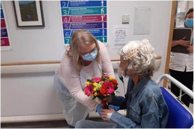 Niece Leigh Brown giving flowers to Gail ahead of the wedding ceremony last Friday, May 21.