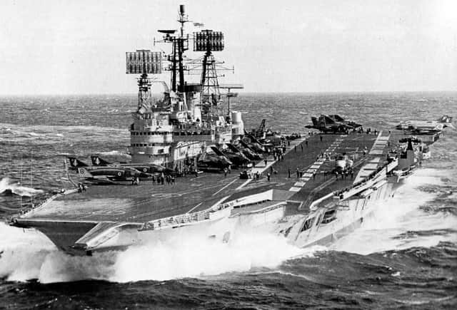 Seen in 1977 is HMS Ark Royal with a flight of Phantom, Buccaneer and Gannet aircraft on her flight deck.