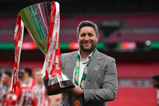Sunderland head coach Lee Johnson celebrates with the Papa John's Trophy after the Papa John's Trophy final match against Tranmere Rovers.