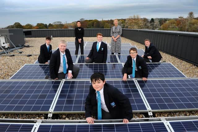 Kepier Academy's Eco Club committee and teachers on the school roof with the recently installed solar panels.
