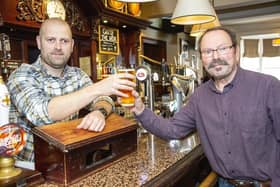 Fitzgerald's manager Matty Downs serves up a great pint of beer to customer Richard Allison. Picture by Michael Gant.