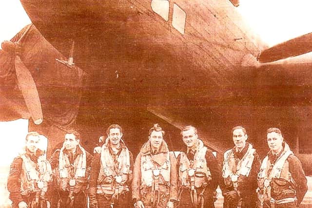 Mr Vandervelde (second from left) pictured with a Halifax bomber during his Second World War service.