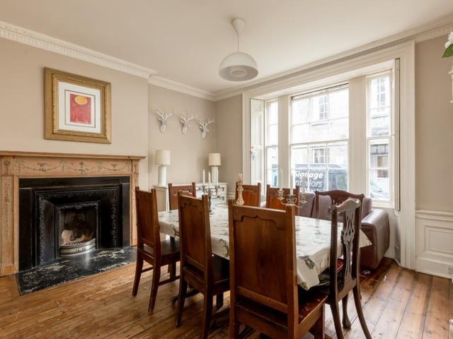 Dining room with stunning Adam fireplace and wooden floor.