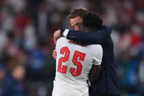 England manager Gareth Southgate consoles a distraught Bukayo Saka after the teenager's penalty miss at the Euro 2020 final at Wembley.