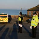 Police officers stop to issue compliance letters to motorists travelling from afar to South Shields seaside, in South Tyneside over the weekend