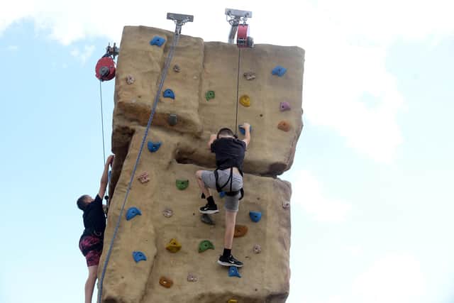 Children on the mobile climbing wall.
