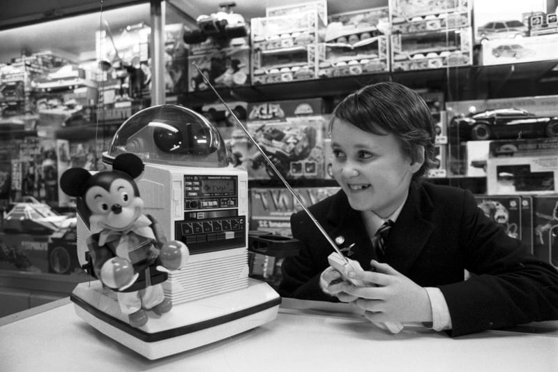 Elliot Blythe (son of Scotsman writer Stuart Blythe) playing with a remote-controlled Omnibot robot in Jenners department store in Edinburgh, November 1986.