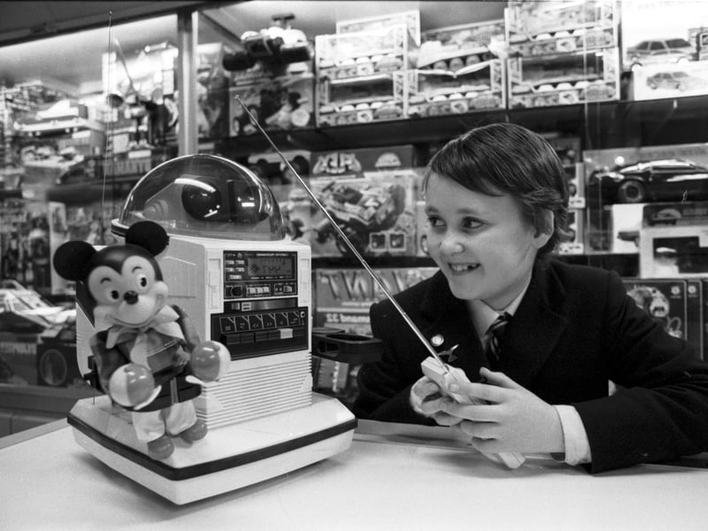 Elliot Blythe (son of Scotsman writer Stuart Blythe) playing with a remote-controlled Omnibot robot in Jenners department store in Edinburgh, November 1986.