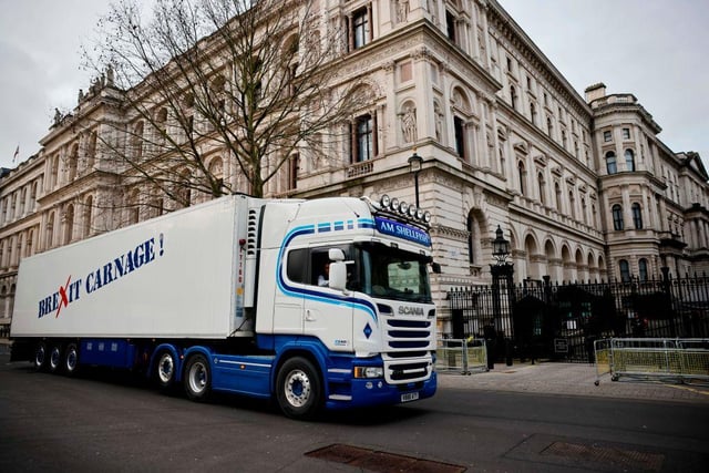 A truck drives past Downing Street with a message that reads "Brexit carnage!" in a protest action by Scottish fishermen against post-Brexit red tape and coronavirus restrictions, which they say could threaten the future of the industry, in London. (Photo by Tolga Akmen / AFP)
