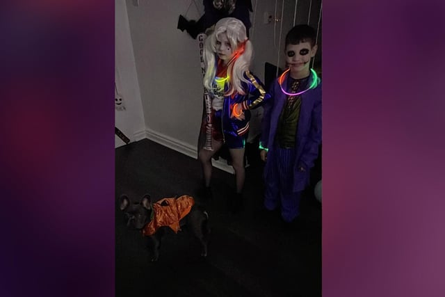 Lilly, age 9, Alfie, age 7, and Buster the dog celebrating Halloween.
