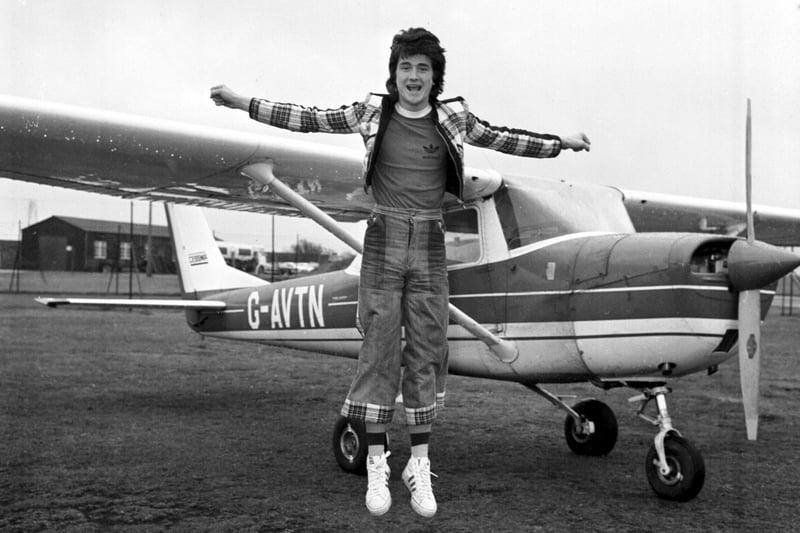 Les McKeown of the Bay City Rollers takes flying lessons at Turnhouse airport  (Edinburgh airport) in April 1975.