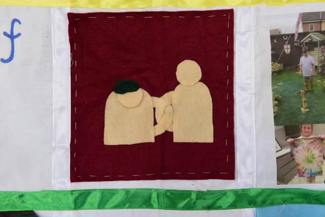 Ava Reynolds's quilt patch showing how people came together to help each other during the pandemic.