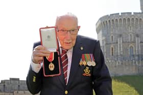 Captain Tom Moore poses with his medal after being made a Knight Bachelor during an investiture at Windsor Castle in July 2020. Picture: Chris Jackson/Pool/AFP via Getty Images.