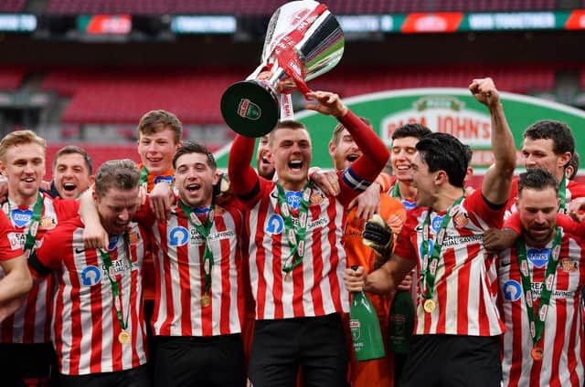 Max Power of Sunderland and team mates celebrate with the Papa John's Trophy.