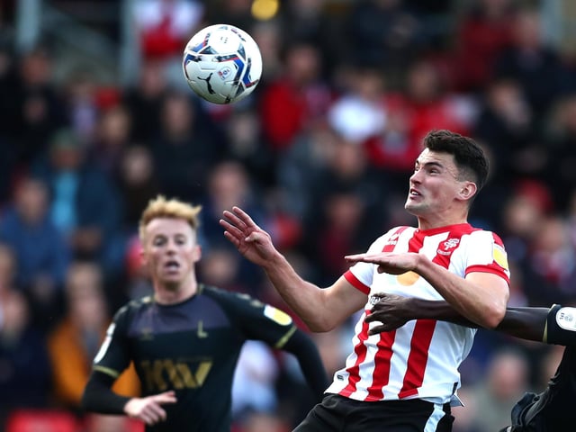 The defender remains at Lincoln City in League One despite links to Sunderland
