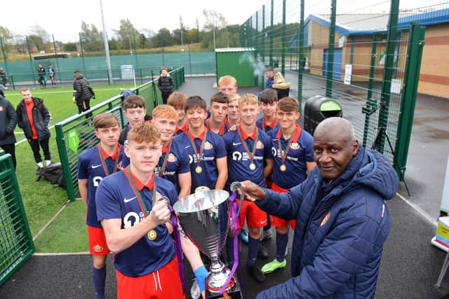 Sunderland AFC legend Gary Bennett presents Sunderland Scholars with the winning cup at the anti-racism football event.