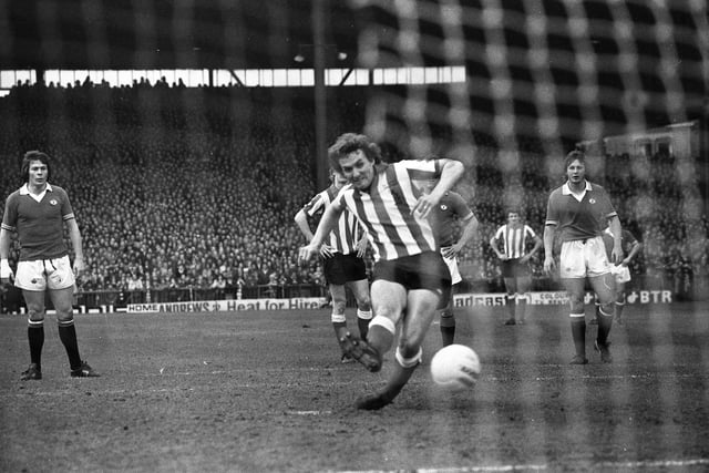 Tony Towers showing fierce concentration as he slams home a penalty against Manchester United.
