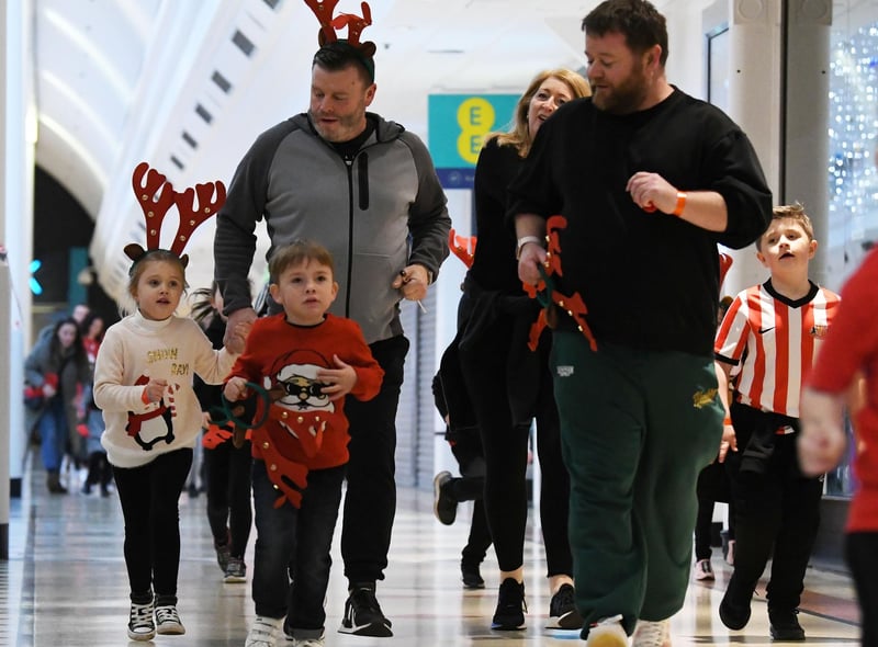 Dads running with their children in the Reindeer Dash.