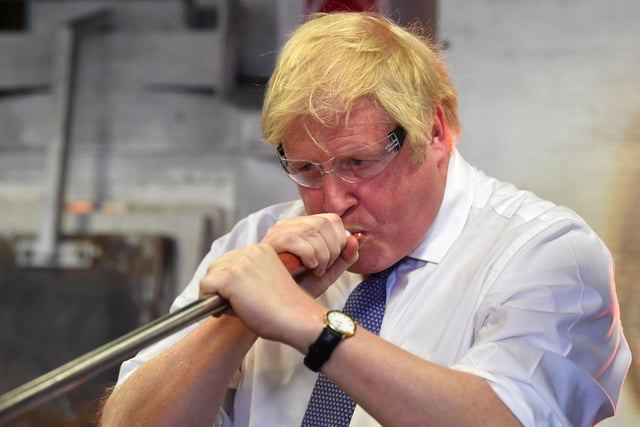 Boris Johnson blowing glass before chairing a cabinet meeting at the National Glass Centre. Photo: Paul Ellis/PA Wire.