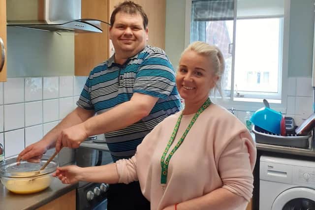 Chris with his support worker baking his favourite sweet treats.