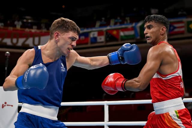 TOKYO, JAPAN - JULY 25: Manish Kaushik (R) of India exchanges punches with Luke McCormack of Great Britain during the Men's Light (57-63kg) on day two of the Tokyo 2020 Olympic Games at Kokugikan Arena on July 25, 2021 in Tokyo, Japan. (Photo by Luis Robayo - Pool/Getty Images)