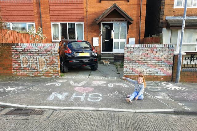 Six year-old Rhed Hendry displays the artwork she created for her dad, great-nana and the NHS.
