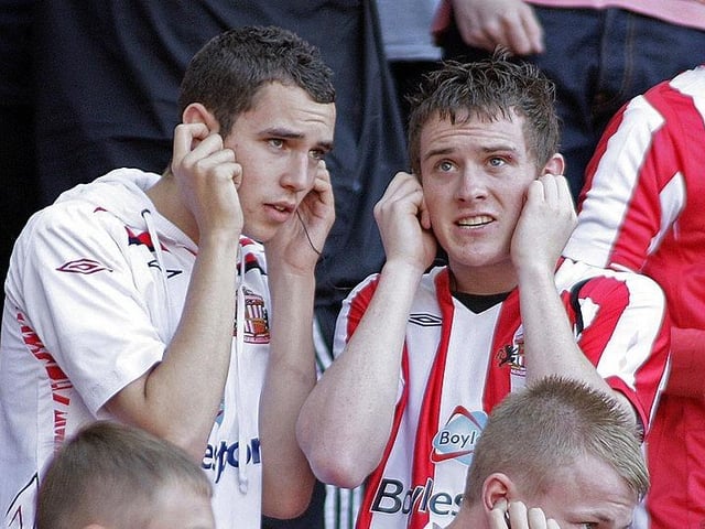 Sunderland's fans listen on radios for results as they avoid being being relegated despite losing 3-2 to Chelsea in the English Premier League football on May 24, 2009.