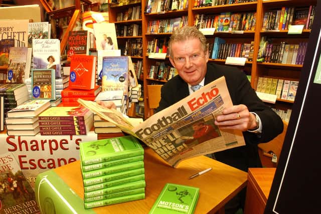 John reads a copy of the Football Echo in 2004.