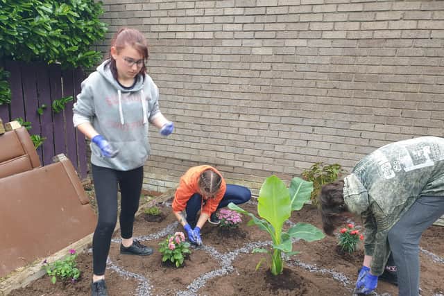 Youngsters working on the flower and herb garden at Whitby Drive Care Home.