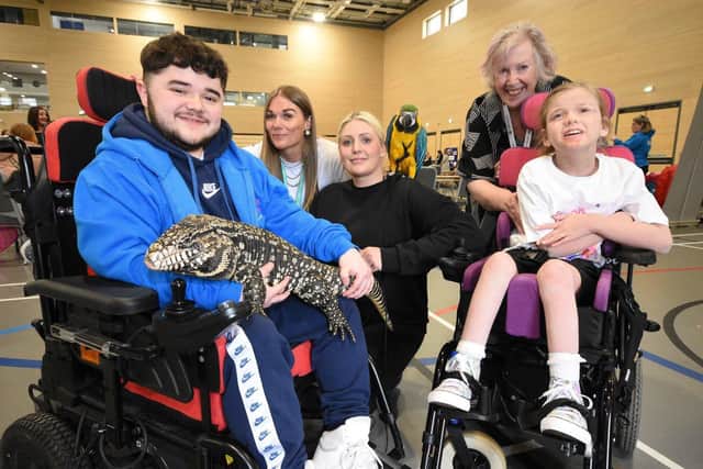 From left: Matthew Pretlel (and Terry the tegu), Kelsie Sanderson trainee therapist with Choice Wellbeing Services, Emma Gibbons from Emma's Exotic Animal Encounters, Maureen Morris from SPCF and Delilah Huggins, 11, with Rio the parakeet.